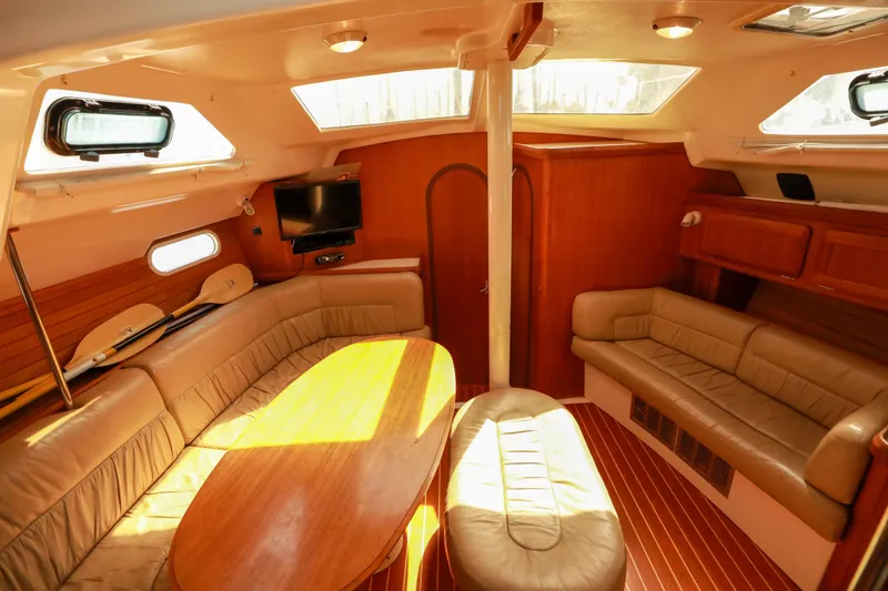 Slide: The Image of Interior of 1997 Hunter Passage 42 yacht with cozy seating and wooden finishes. - 11