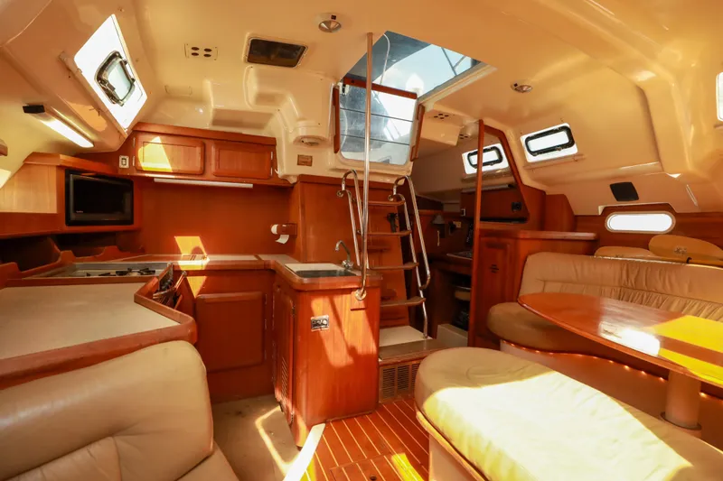 Slide: The Image of Interior of 1997 Hunter Passage 42 sailboat with wooden cabinetry and seating. - 16
