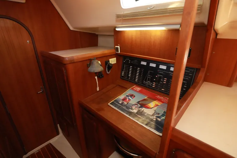 Slide: The Image of 1997 Hunter Passage 42 yacht interior with navigation panel and wooden cabinetry. - 17