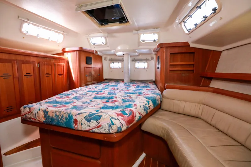 Slide: The Image of Interior of 1997 Hunter Passage 42 yacht with cozy cabin and floral bedding. - 18