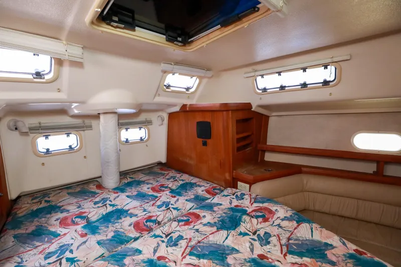 Slide: The Image of Interior cabin of 1997 Hunter Passage 42 sailboat with floral bedding and wooden accents. - 20