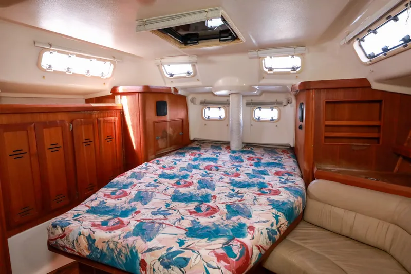 Slide: The Image of Interior cabin of 1997 Hunter Passage 42 yacht with colorful bedding and wooden cabinetry. - 21