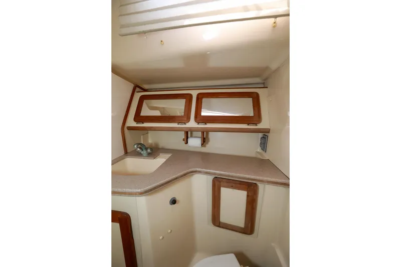 Slide: The Image of Interior of 1997 Hunter Passage 42 yacht bathroom with sink and wooden cabinets. - 24