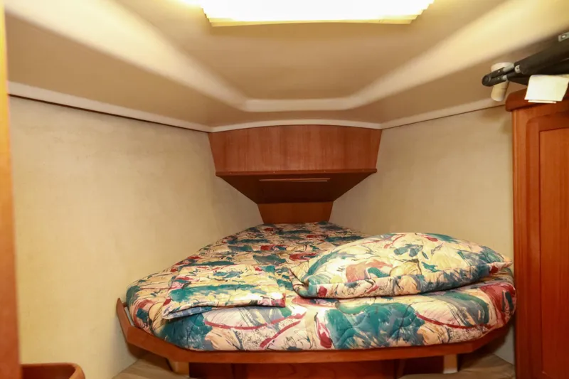 Slide: The Image of Cozy cabin interior of 1997 Hunter Passage 42 sailboat with colorful bedding. - 29