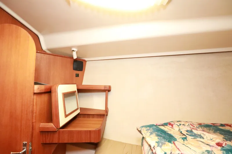 Slide: The Image of Cozy cabin interior of 1997 Hunter Passage 42 sailboat with wooden shelves and bedding. - 31