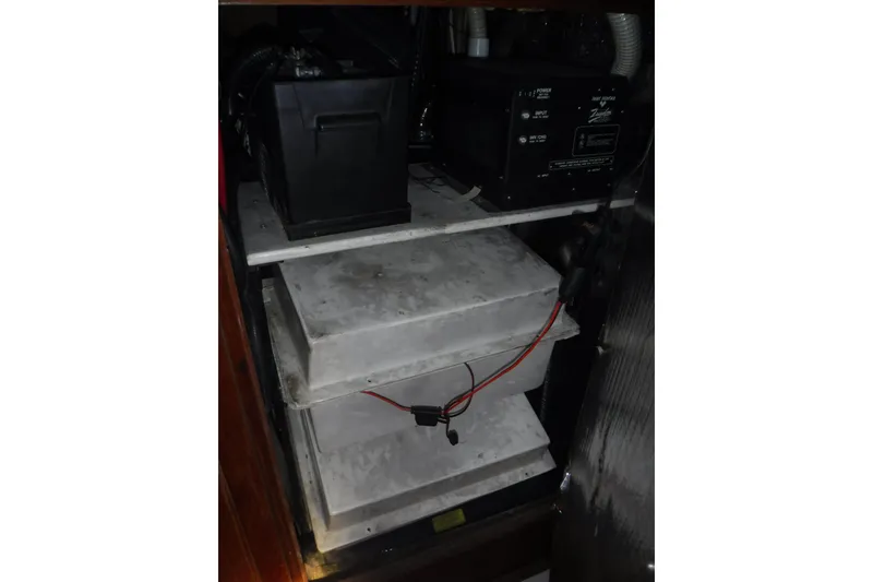 Slide: The Image of Battery compartment of a 1997 Hunter Passage 42 sailboat, featuring electrical components. - 37