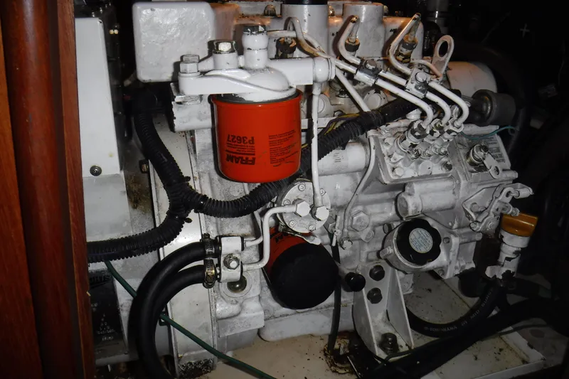 Slide: The Image of Engine compartment of a 1997 Hunter Passage 42 sailboat, featuring mechanical components. - 38