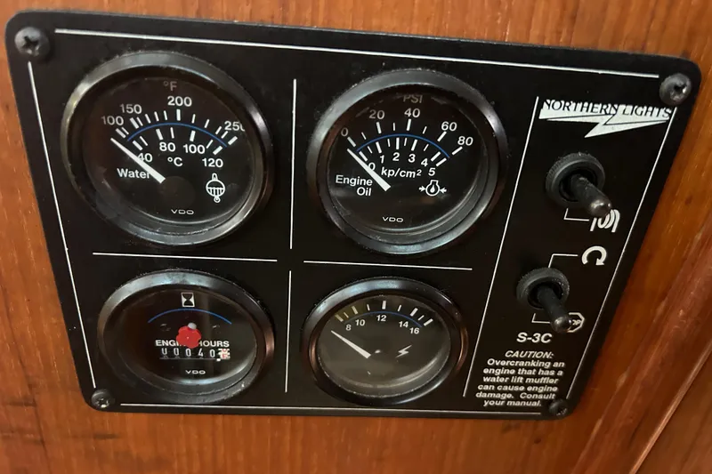 Slide: The Image of Control panel of a 1997 Hunter Passage 42 sailboat with gauges and switches. - 41