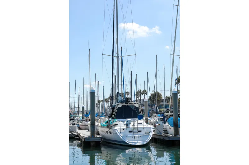 Slide: The Image of Sailboat Hunter Passage 42, 1997 model, docked in a marina under a clear blue sky. - 5
