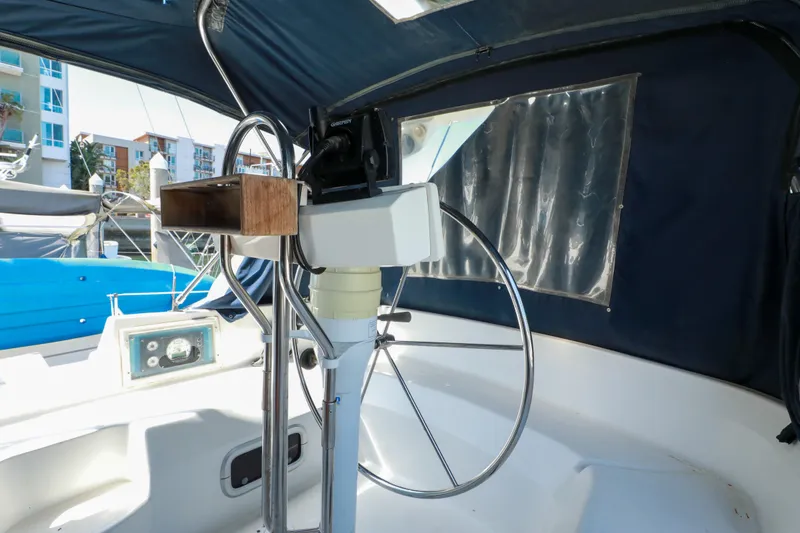 Slide: The Image of Interior view of a 1997 Hunter Passage 42 sailboat cockpit with steering wheel. - 6