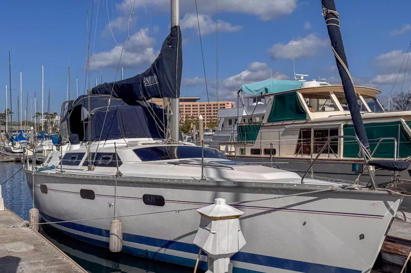 Slide: The Image of 1997 Hunter Passage 42 sailboat docked at marina under blue sky. - 7