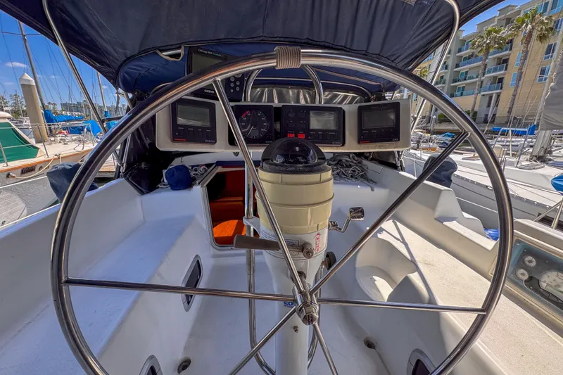 Slide: The Image of Cockpit of 1997 Hunter Passage 42 sailboat with steering wheel and navigation instruments. - 8