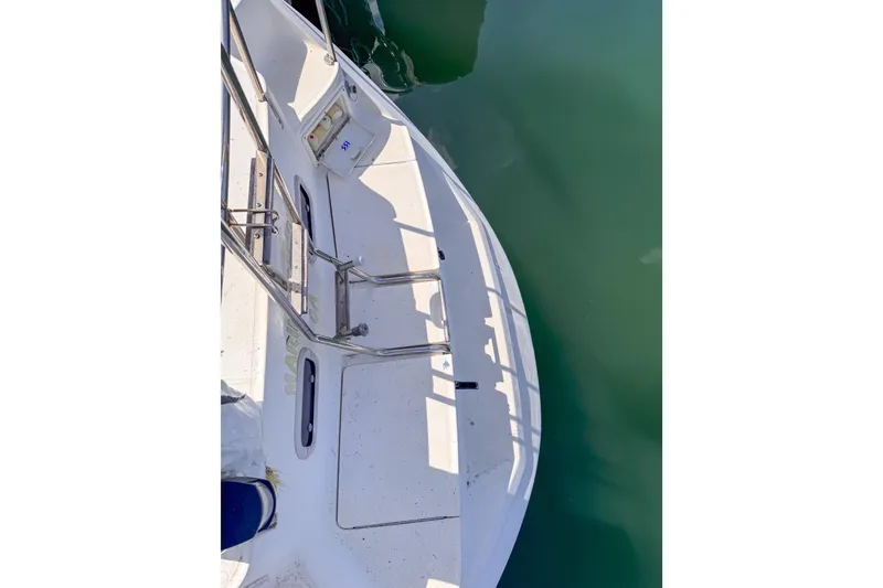 Slide: The Image of Deck view of a 1997 Hunter Passage 42 sailboat, showing railing and water. - 9