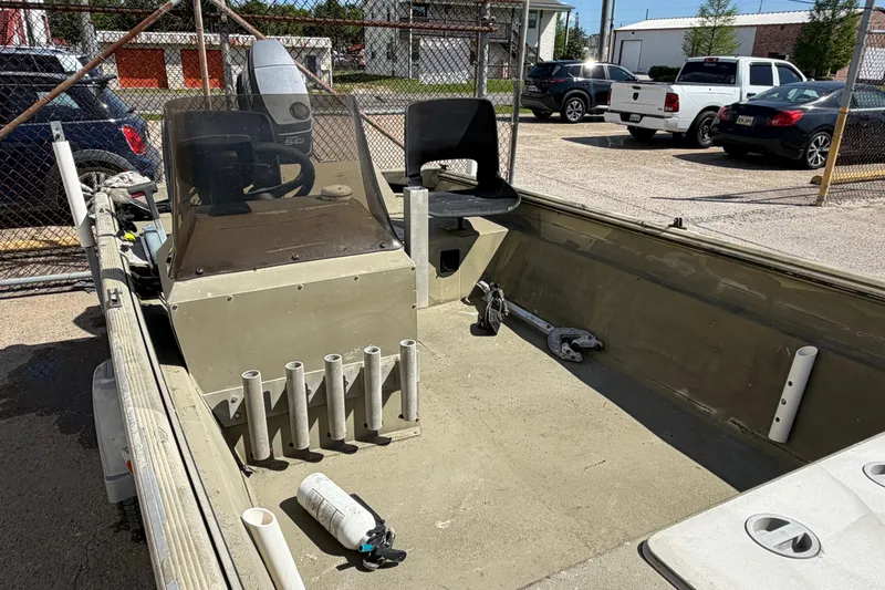 Slide: The Image of 2003 Xpress 1650VJF boat interior with steering console and seating. - 9