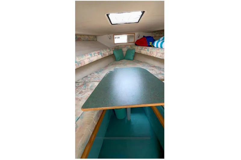Slide: The Image of Interior cabin of 1994 Sea Ray 310 Amberjack with seating and table. - 14
