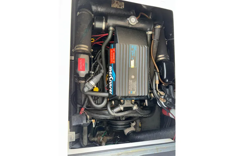 Slide: The Image of Engine compartment of a 1994 Sea Ray 310 Amberjack boat, featuring MerCruiser components. - 16
