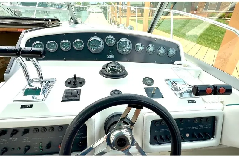 Slide: The Image of Cockpit of 1994 Sea Ray 310 Amberjack boat with steering wheel and control panel. - 9