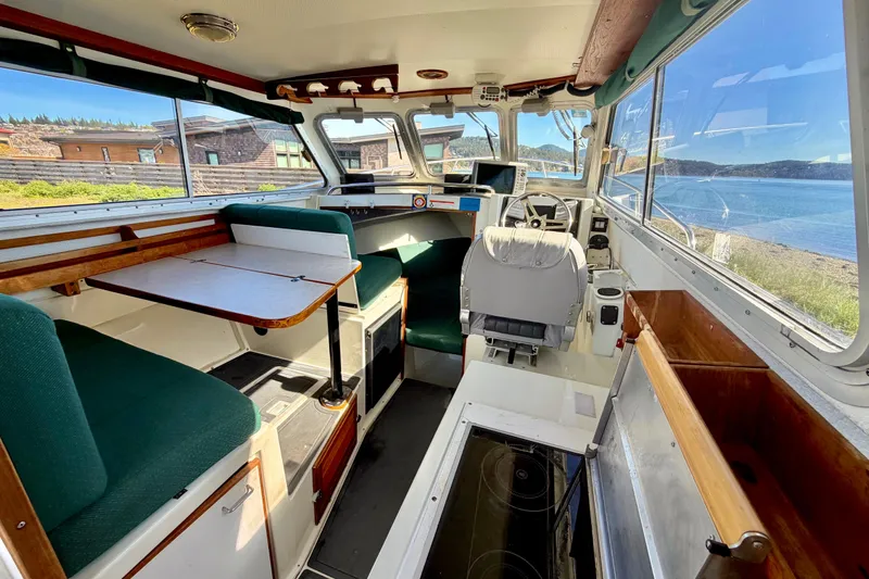 Slide: The Image of Interior of 2001 Skagit Orcas 27XLC boat with seating and navigation area. - 10