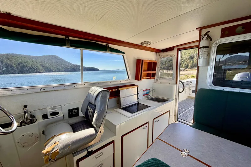 Slide: The Image of Interior of 2001 Skagit Orcas 27XLC boat with scenic water view through windows. - 12