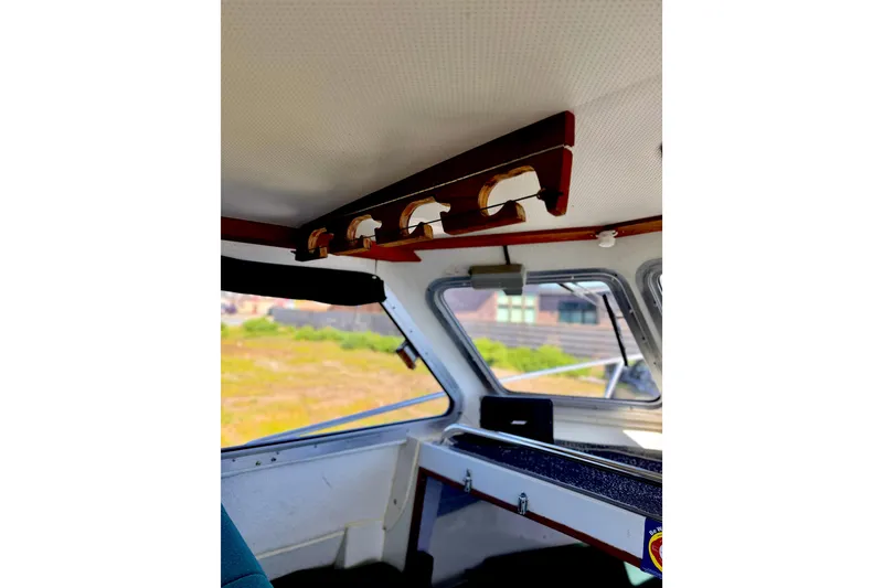 Slide: The Image of Interior view of a 2001 Skagit Orcas 27XLC boat, showcasing ceiling and window details. - 14