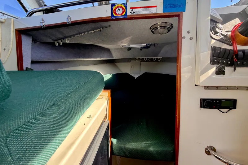 Slide: The Image of Interior cabin of a 2001 Skagit Orcas 27XLC boat with green upholstery. - 16