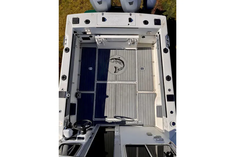 Slide: The Image of 2001 Skagit Orcas 27XLC boat deck with clean, spacious layout and fishing rod holders. - 5