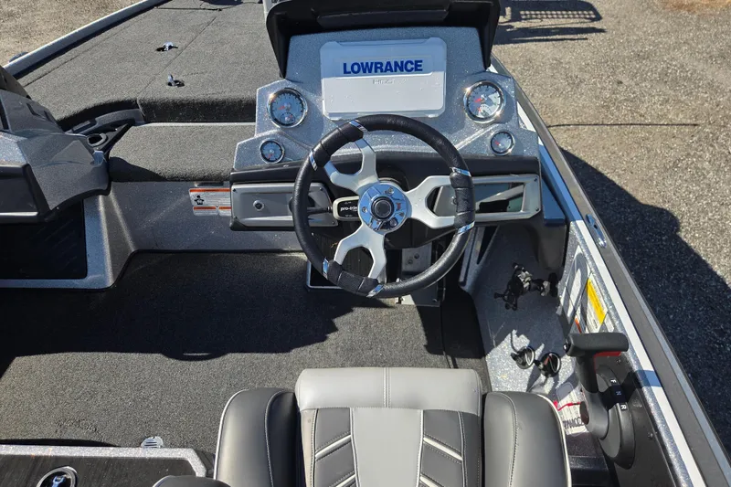 Slide: The Image of 2023 Nitro Z19 boat dashboard with steering wheel and Lowrance display. - 12