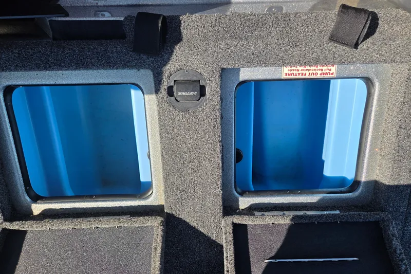 Slide: The Image of Storage compartments in a 2023 Nitro Z19 boat, featuring blue interiors and carpeted edges. - 13