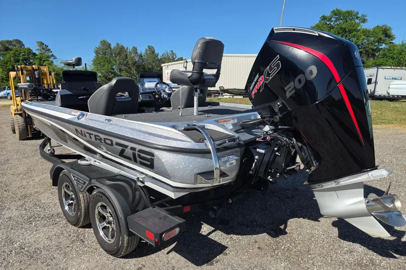Slide: The Image of 2023 Nitro Z19 boat with powerful 200 HP engine, parked outdoors. - 5