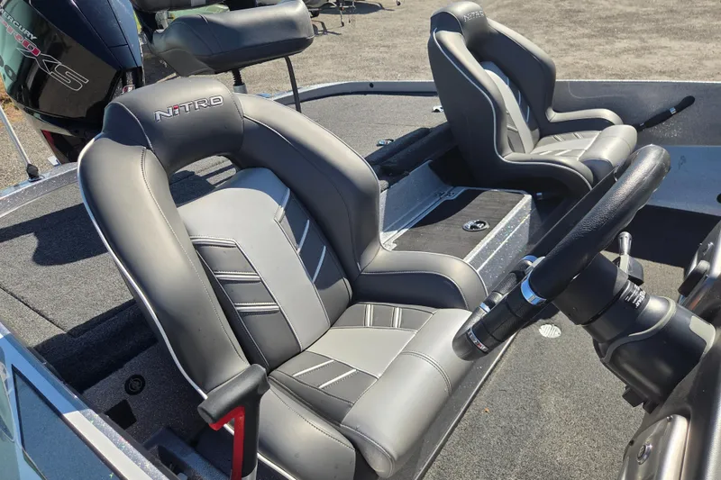 Slide: The Image of 2023 Nitro Z19 boat interior with sleek gray seats and steering wheel. - 7