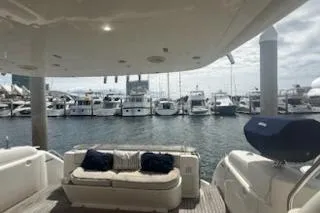 Slide: The Image of Sealine T51 yacht deck view, 2000 model, overlooking marina with multiple boats docked. - 11