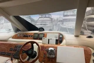 Slide: The Image of Interior view of a 2000 Sealine T51 yacht cockpit with wooden dashboard. - 13