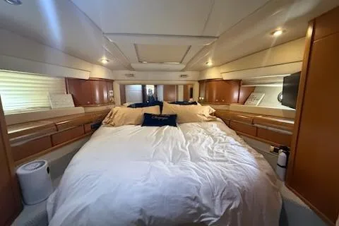 Slide: The Image of Luxurious bedroom interior of a 2000 Sealine T51 yacht with elegant wood finishes. - 15