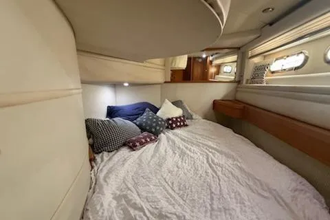 Slide: The Image of 2000 Sealine T51 yacht cabin with cozy bedding and porthole windows. - 16