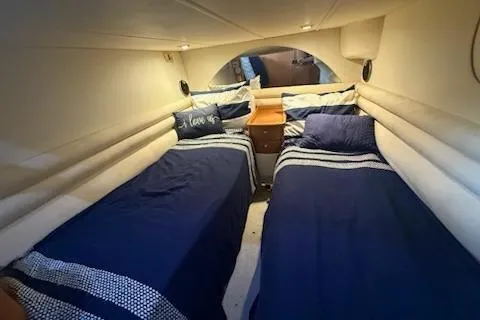 Slide: The Image of Twin beds in a 2000 Sealine T51 yacht cabin with blue bedding. - 17
