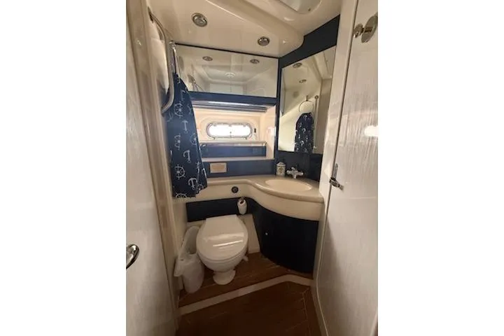 Slide: The Image of Bathroom interior of 2000 Sealine T51 yacht, featuring modern fixtures and nautical decor. - 18