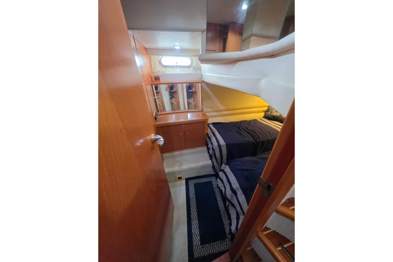 Slide: The Image of Interior cabin of 2000 Sealine T51 MY yacht with twin beds and wooden cabinetry. - 27