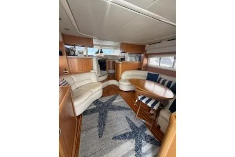 Slide: The Image of Twin beds in a 2000 Sealine T51 yacht cabin with blue bedding. - 28