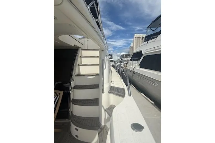 Slide: The Image of 2000 Sealine T51 yacht docked, featuring exterior stairs and sleek design. - 3