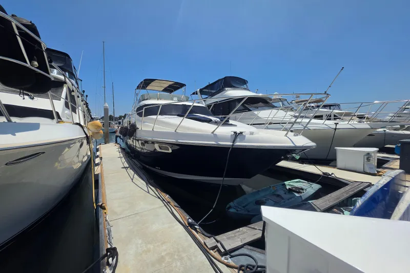 Slide: The Image of 2000 Sealine T51 MY yacht docked at marina under clear blue sky. - 36