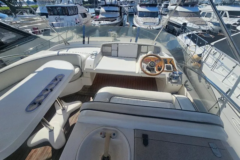 Slide: The Image of Cockpit view of a 2000 Sealine T51 Motor Yacht docked at a marina. - 5