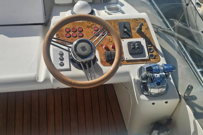 Slide: The Image of Steering wheel and controls of a 2000 Sealine T51 Motor Yacht cockpit. - 8