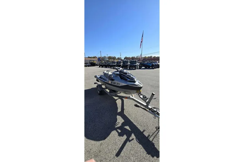 Slide: The Image of 2024 Sea-Doo GTX Limited 300 on trailer in parking lot under clear blue sky. - 5