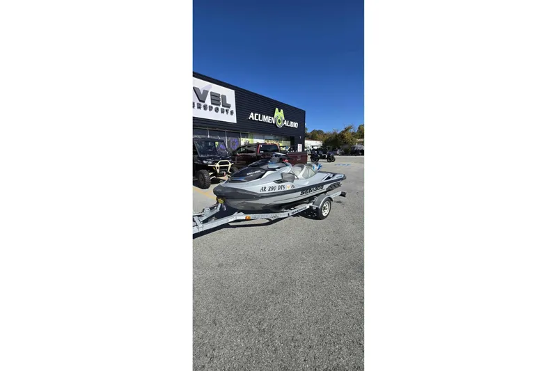 Slide: The Image of 2024 Sea-Doo GTX Limited 300 on trailer outside dealership, clear blue sky. - 4