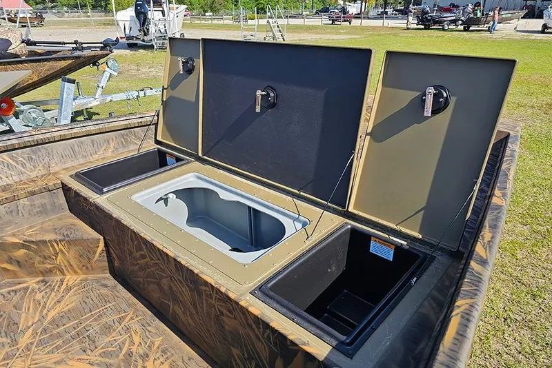 Slide: The Image of Open storage compartments on a 2026 G3 Gator Tough 17 SC boat, showcasing interior features. - 15