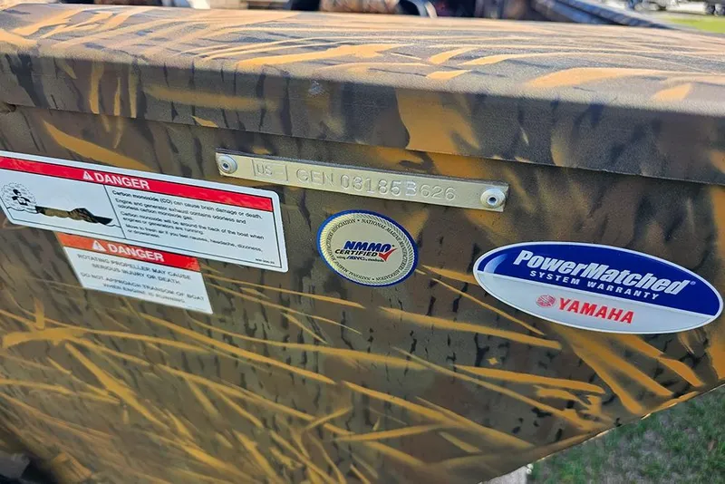 Slide: The Image of Camouflage-patterned G3 Gator Tough 17 SC boat with warning labels and Yamaha warranty sticker. - 16