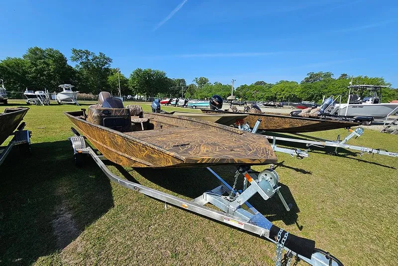 Slide: The Image of 2026 G3 Gator Tough 17 SC boat on trailer, camo design, parked on grass. - 5