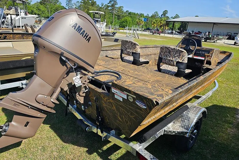 Slide: The Image of 2026 G3 Gator Tough 17 SC boat with Yamaha motor, camo design, on trailer. - 7