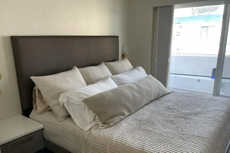 Slide: The Image of Cozy bedroom with plush bedding and large window, Adonia Max'd Out Trip 2021. - 10