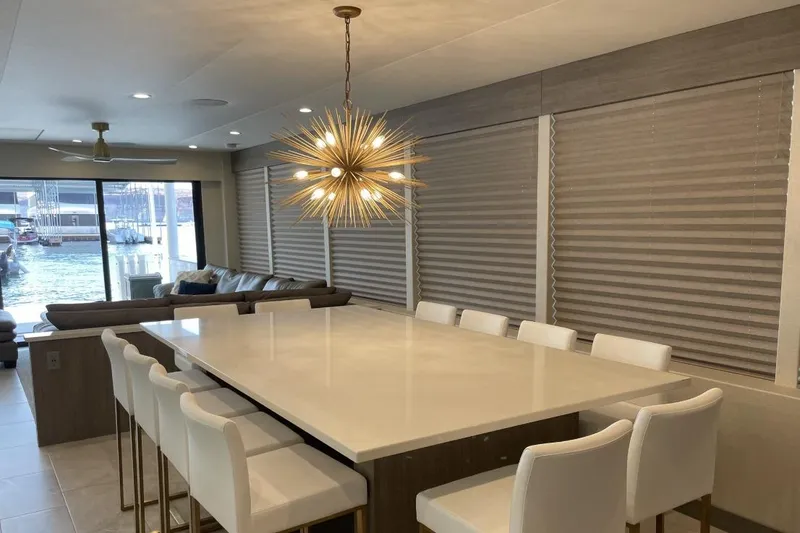 Slide: The Image of Modern dining area on Adonia Max'd Out Trip 7A & 7B, featuring elegant lighting and seating. - 12